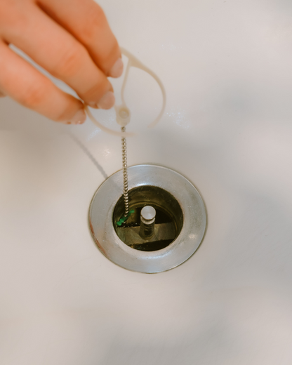 DrainWig hair catcher installed into a bathtub drain