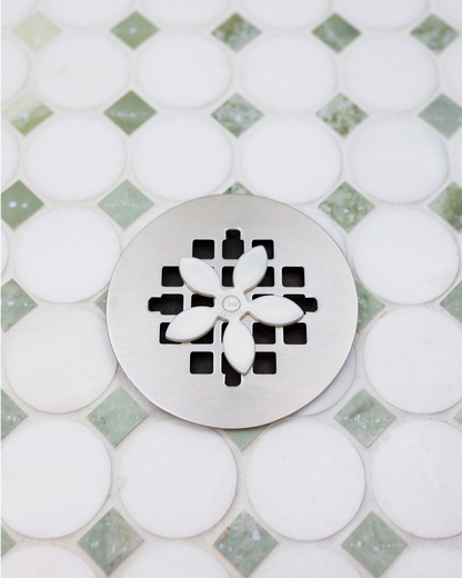 white-daisy|DrainWig hair catcher installed in shower drain