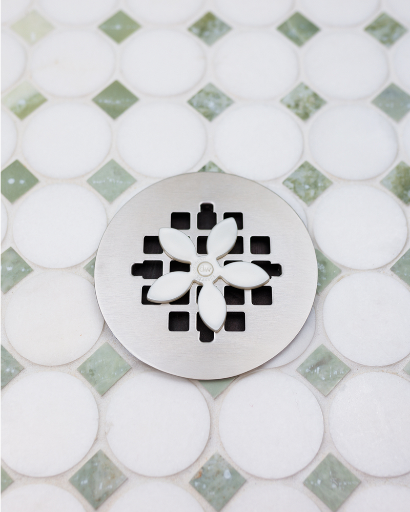 white-daisy|DrainWig hair catcher installed in shower drain